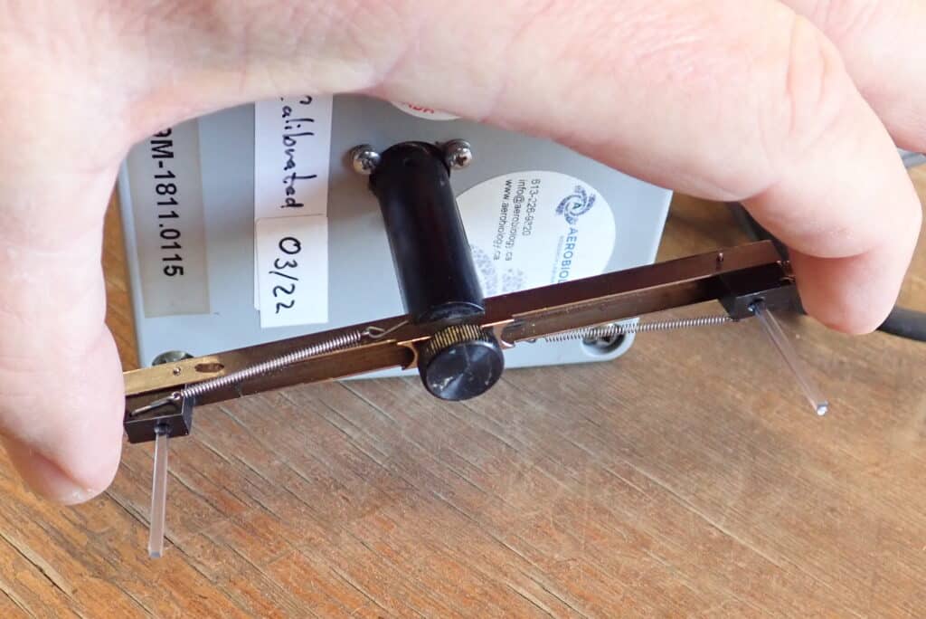 a close-up of a rotorod tester tool (made to collect sclerotinia spores per cubic metre of air per hour in a canola field)