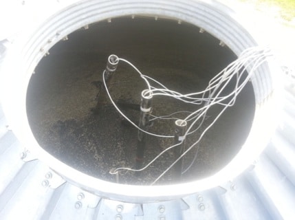 Feeding sensor wires through probes in the bin; Photo credit: PAMI